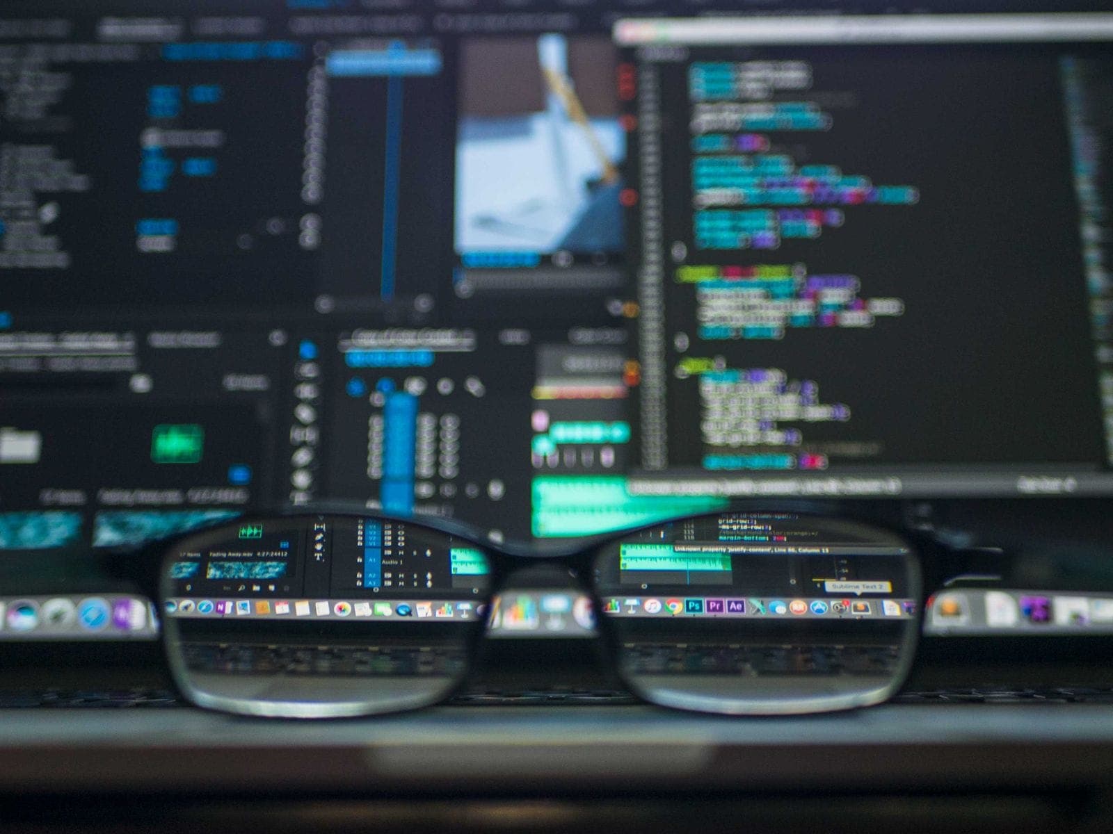 Source code on multiple monitors seen through eyeglasses